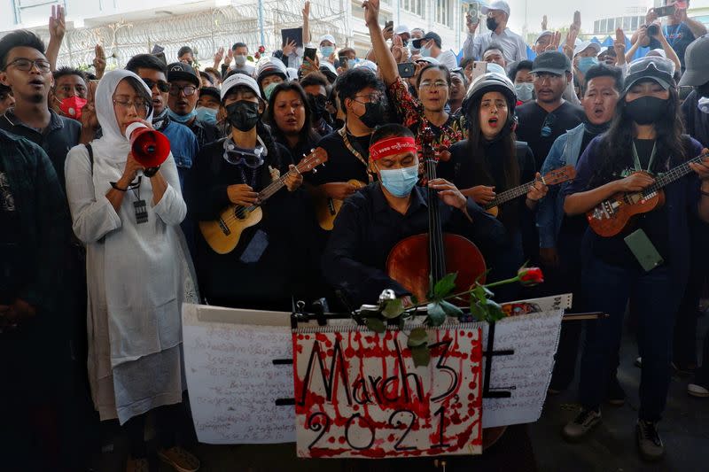 People attend the funeral of Angel, 19-year-old protester also known as Kyal Sin who was shot in the head as Mynamar forces opened fire to disperse an an anti-coup demonstration in Mandalay