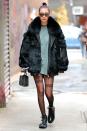 <p>In a black fur coat, oversized tee, Alexander Wang "girls" tights, lace-up leather combat boots, <a href="https://www.stevenalanoptical.com/mens-sunglasses-millbrook-hazel-0306E08E00250560" rel="nofollow noopener" target="_blank" data-ylk="slk:Steven Alan Optical sunglasses;elm:context_link;itc:0;sec:content-canvas" class="link ">Steven Alan Optical sunglasses</a>, a "bella" necklace and a polaroid camera while out in NYC.</p>