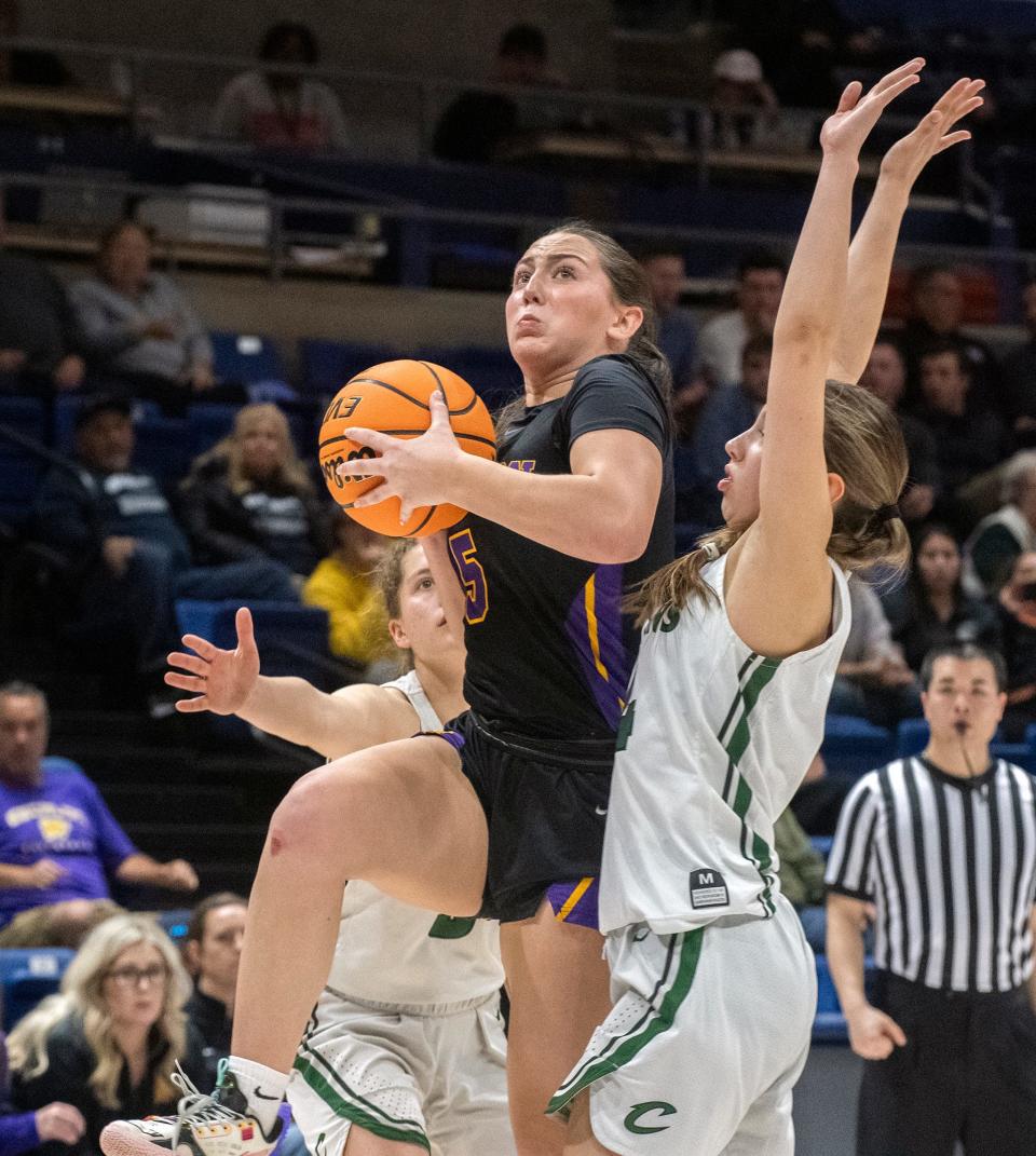 Escalon's Macie Vickers, center, fights her way through Colfax's Kaia Diederichs, left, and Claire Bishop during the Sac-Joaquin Section Div. 4 girls basketball championship game at U.C. Davis' University Credit Union Center in Davis on Feb. 23, 2024. Escalon lost 64-48.