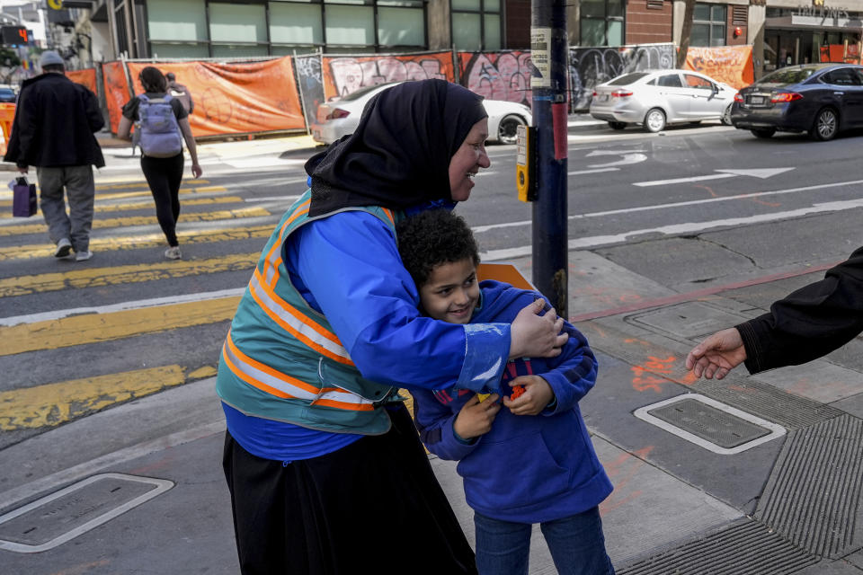 Tatiana Alabsi, left, hugs her nephew Adam Khalid as she roams the Tenderloin neighborhood Wednesday, March 20, 2024, in San Francisco. (AP Photo/Godofredo A. Vásquez)