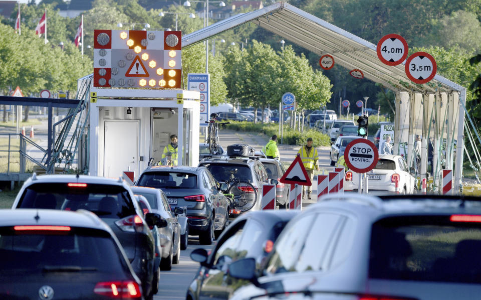 Cars are parked at the Krusau border crossing towards Denmark in Flensburg, Germany, Monday, June 15, 2020. German tourists are allowed to enter Denmark again since midnight. (Carsten Rehder/dpa via AP)