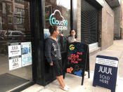 Natalia Pena and Rizza Colon vape outside the shop they work at, Cloud99 Vapes, in Manhattan borough, New York, U.S. September 20, 2018. REUTERS/Melissa Fares