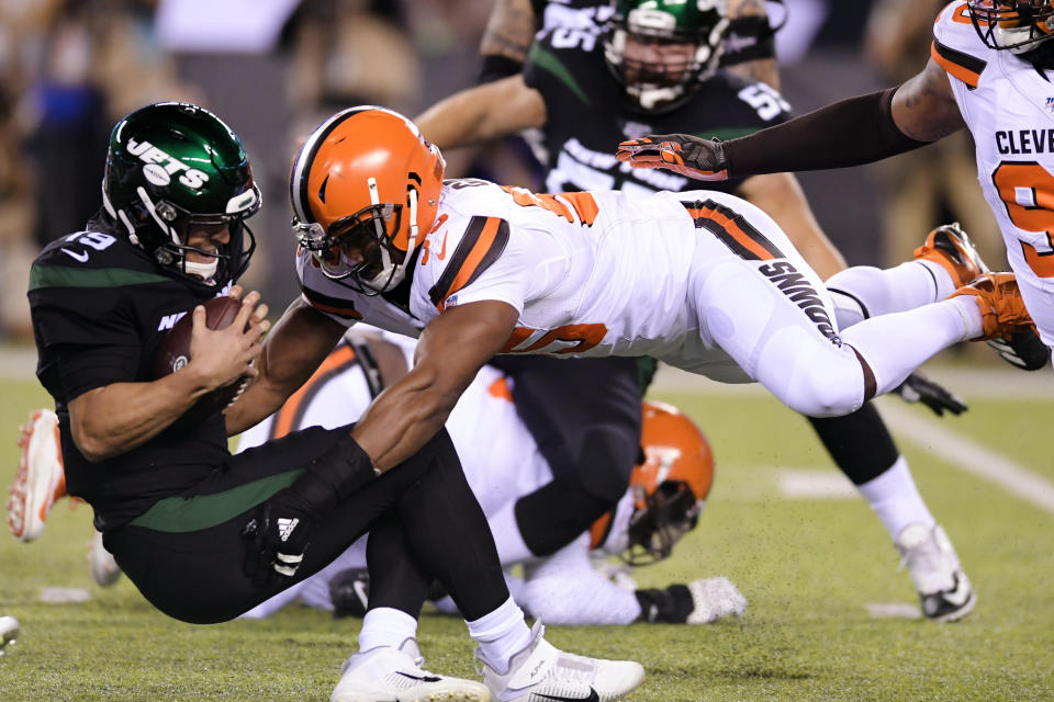 FILE - In this Sept. 16, 2019, file photo, Cleveland Browns' Myles Garrett (95) sacks New York Jets' Trevor Siemian (19) during the first half of an NFL football game in East Rutherford, N.J. Garrett leads the league with five sacks in two games. (AP Photo/Bill Kostroun, File)