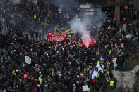 Protesters march during a demonstration Tuesday, Dec. 10, 2019 in Paris. French airport employees, teachers and other workers joined nationwide strikes Tuesday as unions cranked up pressure on the government to scrap upcoming changes to the country's national retirement system. (AP Photo/Thibault Camus)