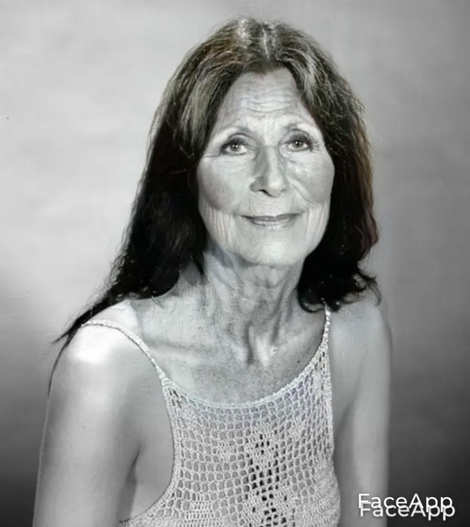 Cher with facial wrinkles and slightly greyed long hair