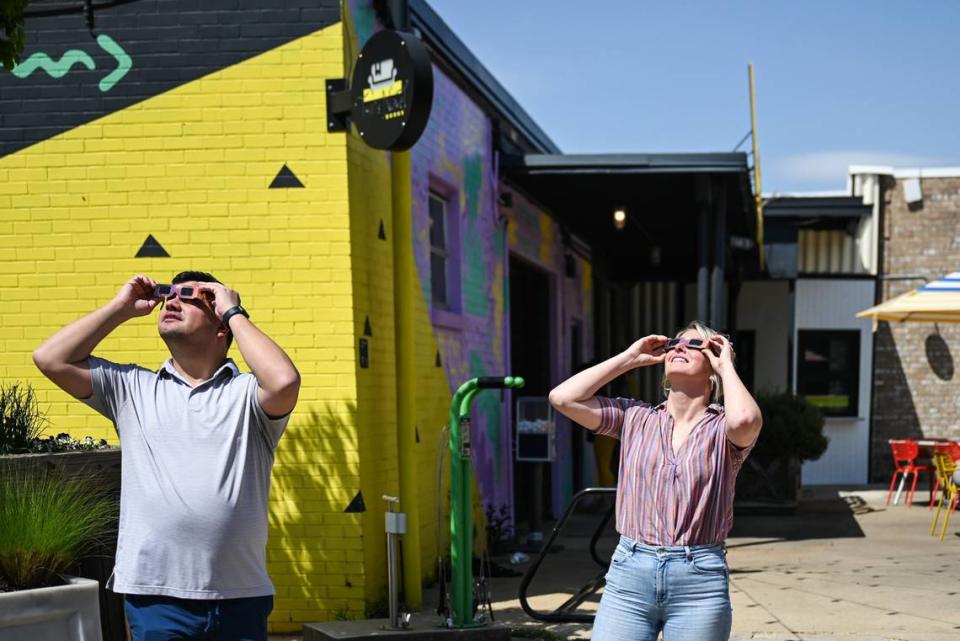 Johnson Bray, left, and Varian Shrum view the solar eclipse at Camp North End.