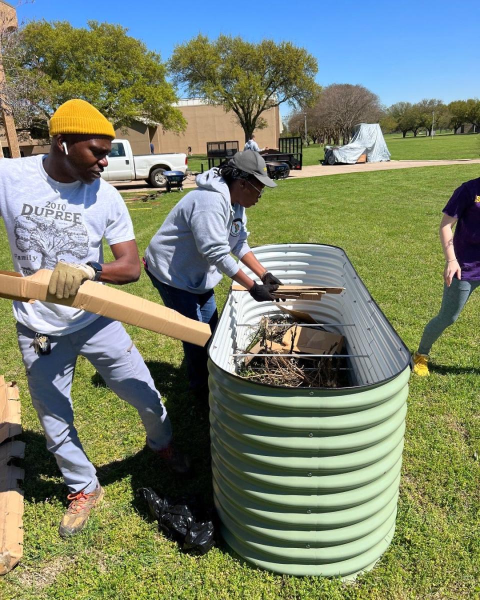 Volunteers from Shreveport Green help the LSUS Red River Garden Club install raised beds as part of the LSUS community garden, which will donate its crop to the LSUS Food Pantry.