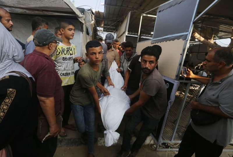 Palestinians carry the bodies of victims of an Israeli attack on a mosque-turned-shelter in Deir al-Balah. Omar Ashtawy/APA Images via ZUMA Press Wire/dpa