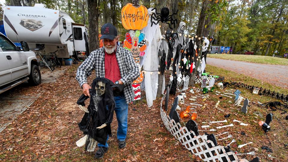 Mike Mosley fine tunes his decorations as campers deck out their campsites with Halloween decorations at the Gunter Hill Campground in Montgomery, Ala., on Friday, Oct. 28, 2022.