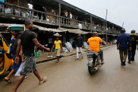 People walk on a street in Araria market in Aba, Nigeria August 19, 2016. REUTERS/Afolabi Sotunde