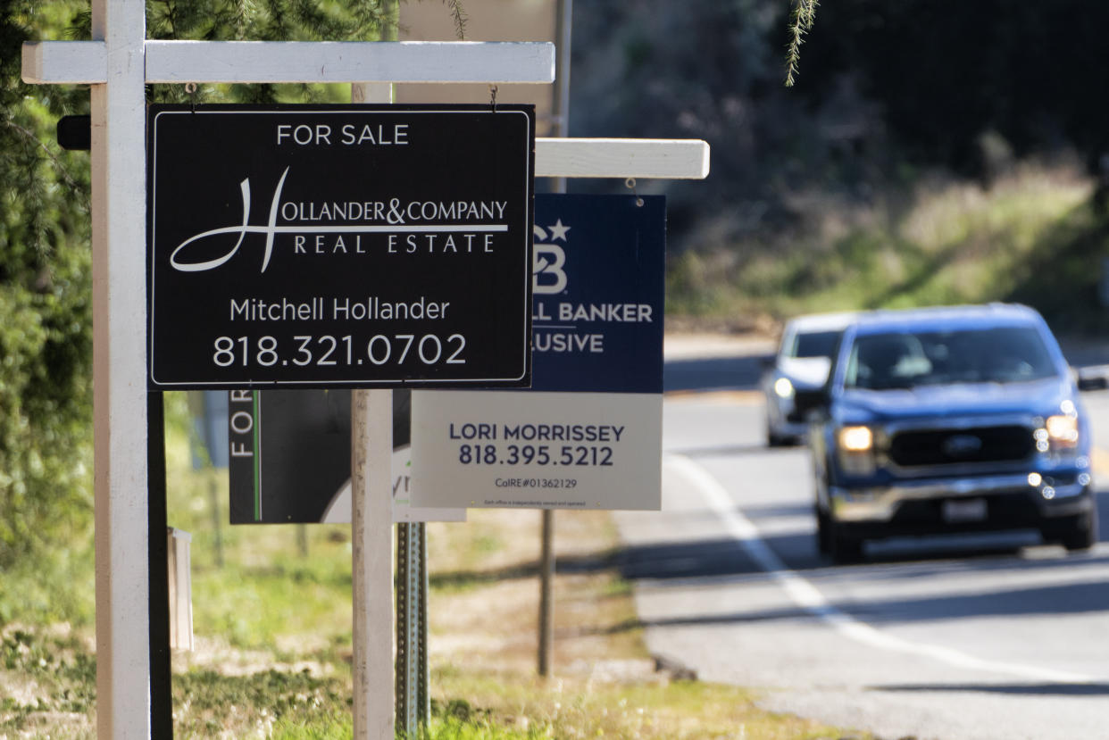Home sale signs are posted along Topanga Canyon road in Los Angeles on Thursday, Oct. 19, 2023. Sales of previously occupied U.S. homes in September fell for the fourth month in a row, grinding to their slowest pace in more than a decade as prospective homebuyers grapple with surging mortgage rates and a near historic-low level of properties on the market. (AP Photo/Richard Vogel)