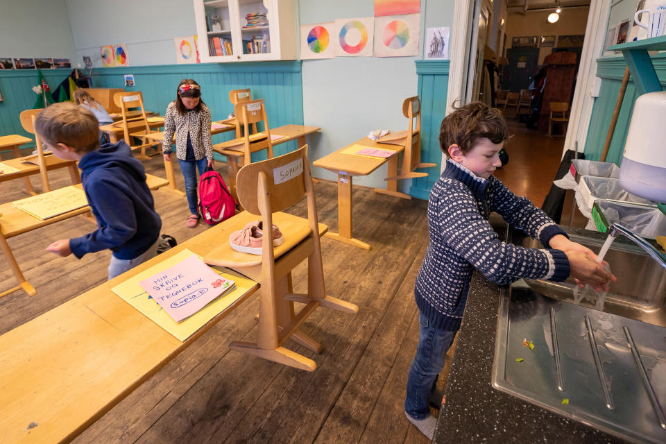 Image: 3rd grader Solen Ostermann at Nordstrand Steinerskole school in Oslo washes his hands after the school reopened (Heiko Junge / NTB Scanpix/AFP via Getty Images file)