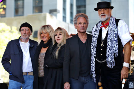 FILE PHOTO: Members of the rock band Fleetwood Mac, (L-R) bassist John McVie, keyboard player and vocalist Christine McVie, vocalist Stevie Nicks, guitarist and vocalist Lindsey Buckingham and drummer and vocalist Mick Fleetwood, stand together on stage after performing a concert on NBC's 'Today' show in New York, NY, U.S., October 9, 2014. REUTERS/Mike Segar/File Photo