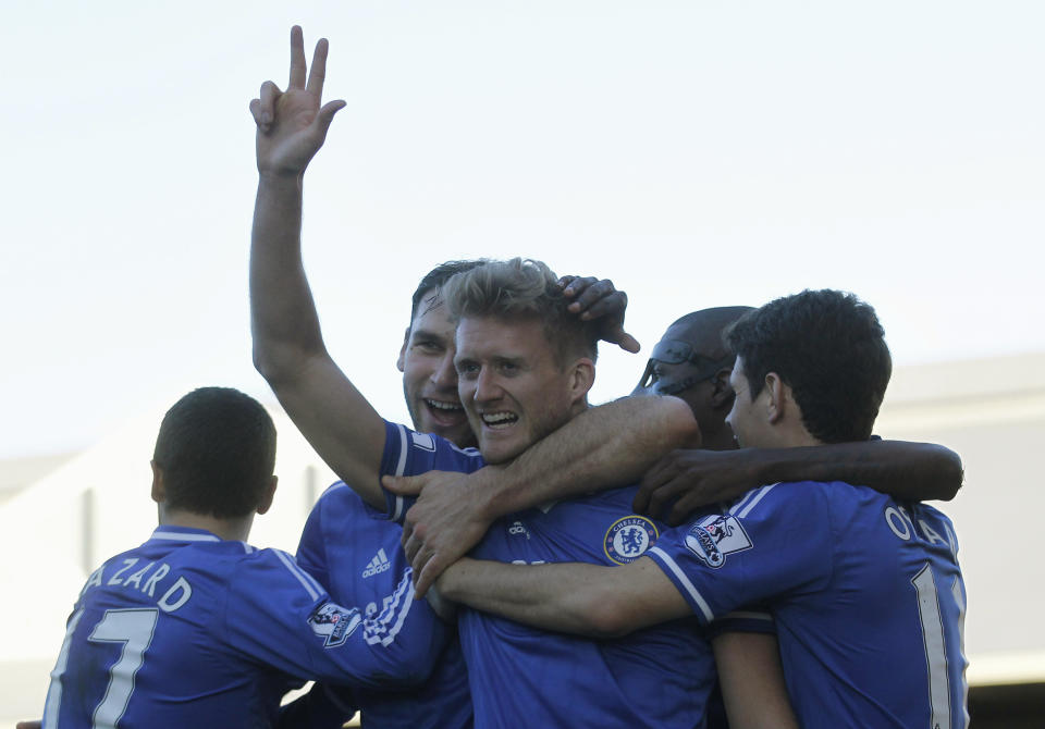 Chelsea's Andre Schurrle, center, celebrates his third goal against Fulham with teammates during their English Premier League soccer match at Craven Cottage, London, Saturday, March 1, 2014. (AP Photo/Sang Tan)