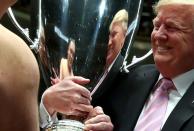 FILE PHOTO: United States President Donald Trump presents the President's Cup trophy to rising Japanese wrestler Asanoyama, who won a 15-day Summer Grand Sumo tournament at the Kokugikan sumo venue in Tokyo.