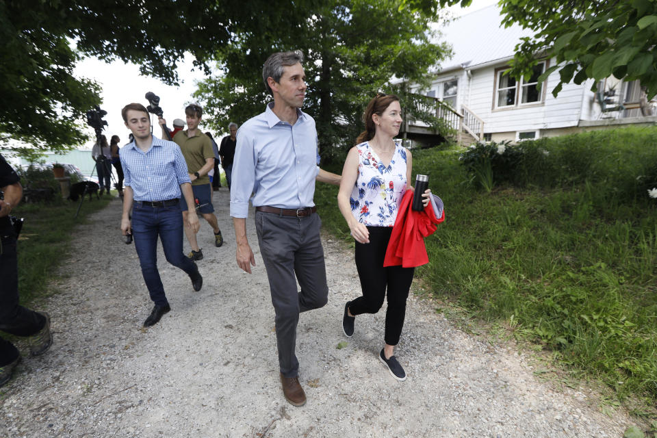 Democratic presidential candidate Beto O'Rourke walks with his wife Amy after touring the Coyote Run Farm, Friday, June 7, 2019, in Lacona, Iowa. (AP Photo/Charlie Neibergall)