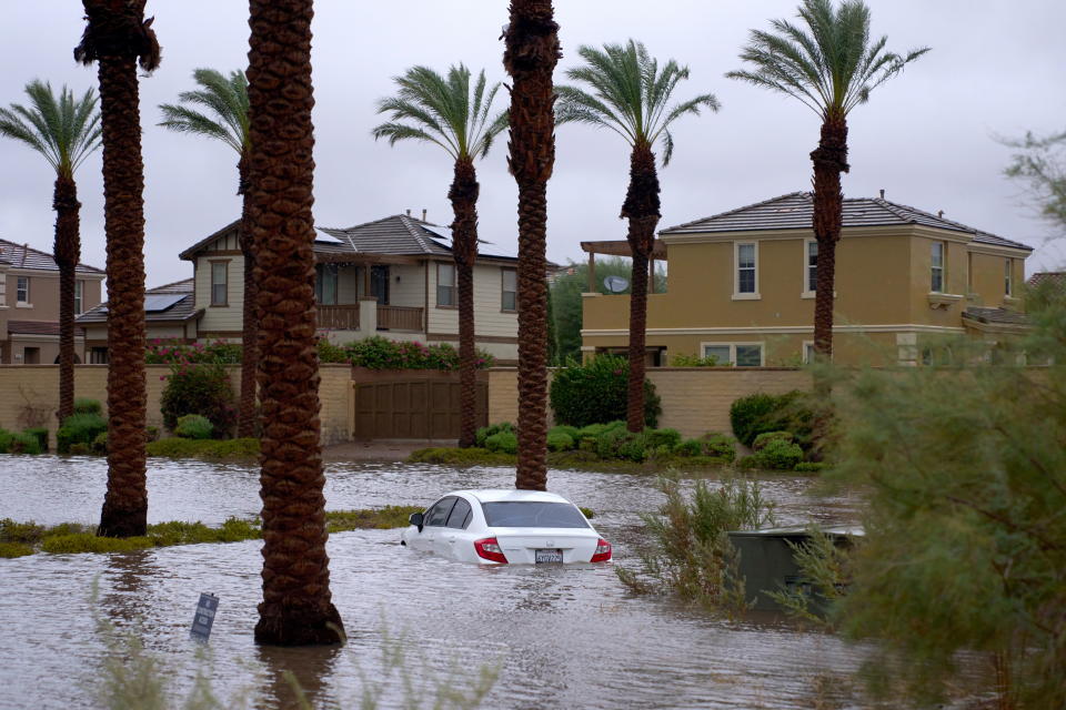 A car is submerged in floodwaters in Cathedral City, Calif.