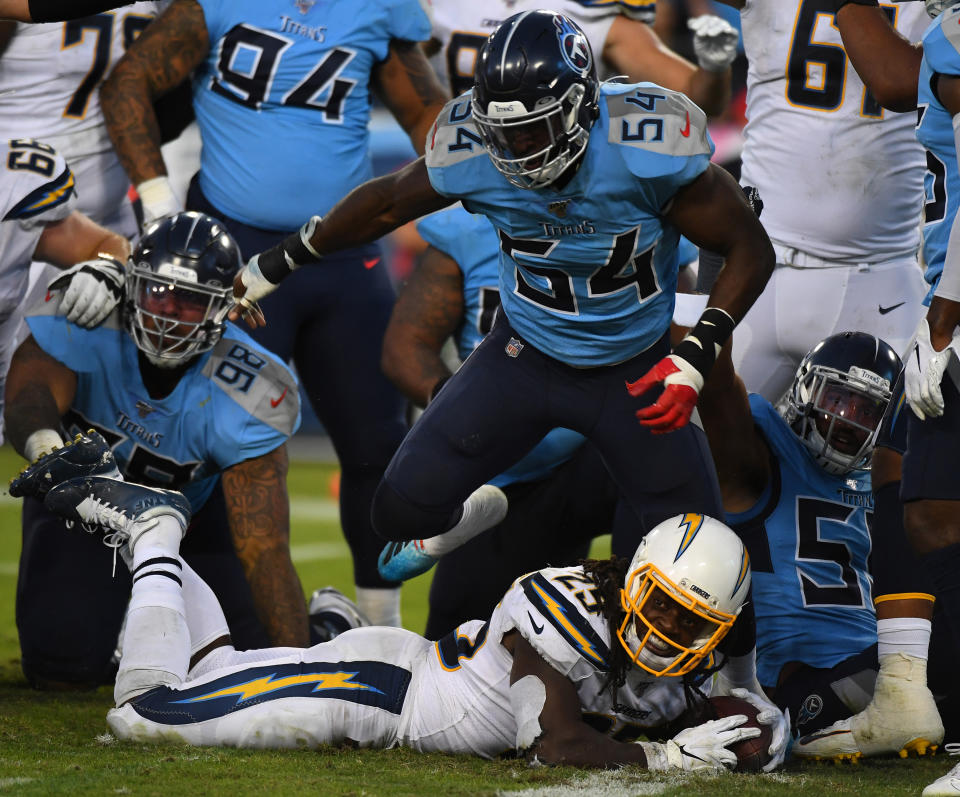 Oct 20, 2019; Nashville, TN, USA; Los Angeles Chargers running back Melvin Gordon (25) is stopped short of the goal line by Tennessee Titans inside linebacker Rashaan Evans (54) during the second half at Nissan Stadium. Mandatory Credit: Christopher Hanewinckel-USA TODAY Sports