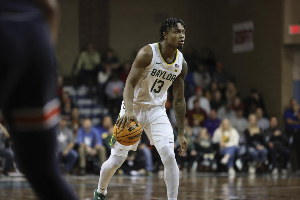 Baylor guard Langton Love (13) dribbles the ball while surveying the court during an NCAA college basketball game against Auburn, Tuesday, Nov. 7, 2023, in Sioux Falls, S.D. (AP Photo/Josh Jurgens)