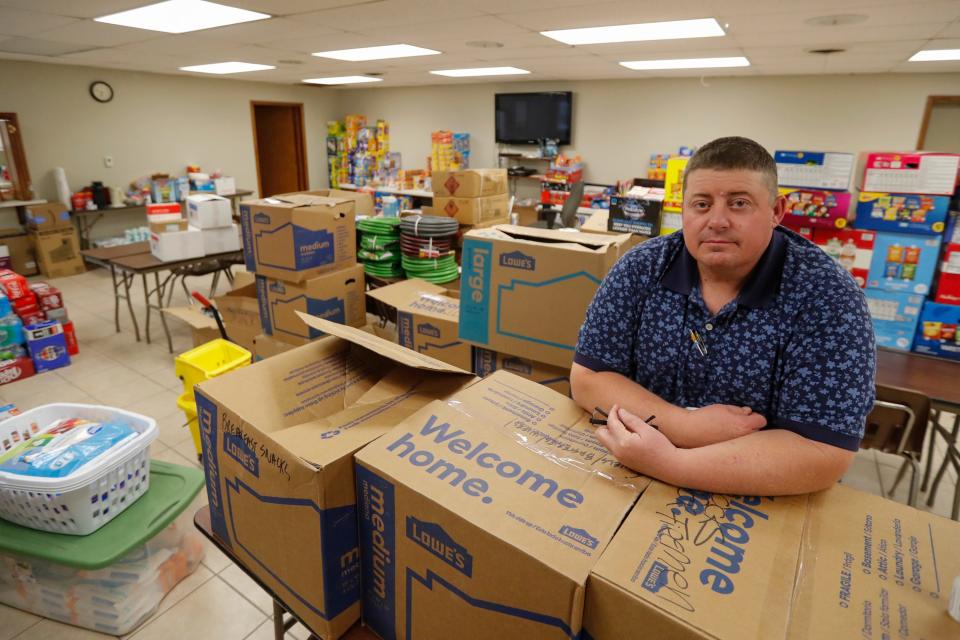 Canadian Volunteer Fire Department Fire Chief Scott Brewster stands among some of the many items donated to the department. Canadian residents were cleaning up and recovering from the massive wildfires that burned much of the northern Texas Panhandle.