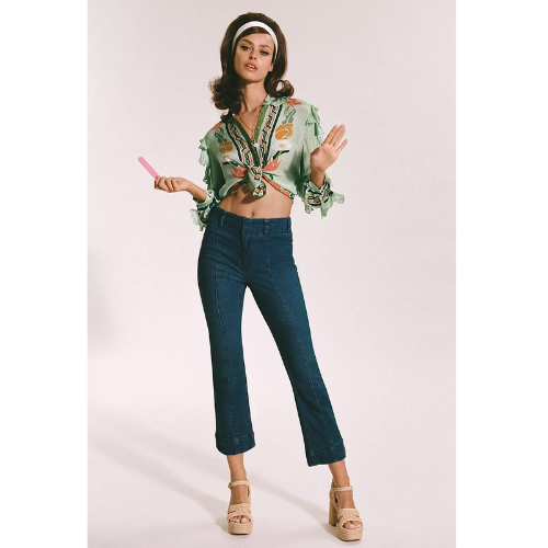 model wearing dark wash jeans and green floral long sleeve top