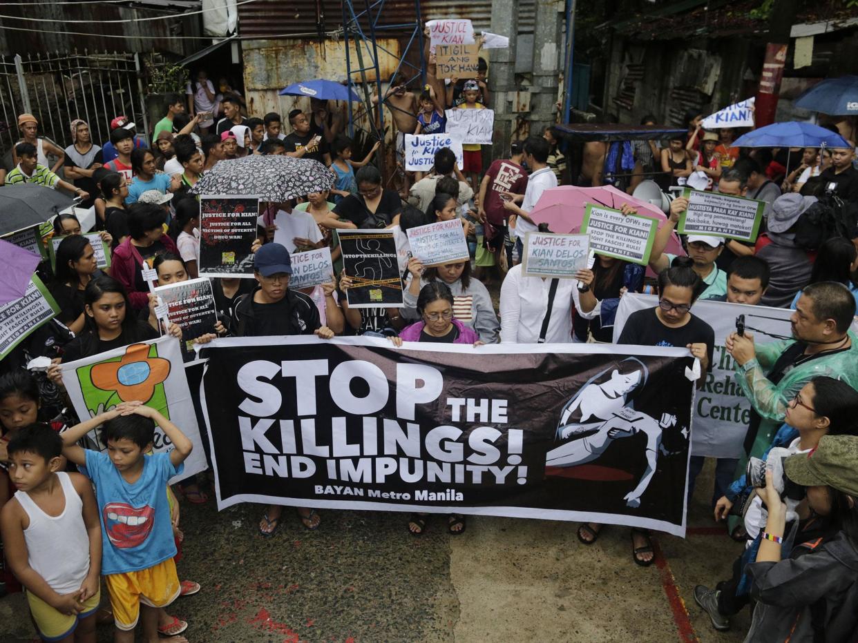 Protesters hold placards calling for justice for student Kian Loyd delos Santos at a wake in Kaloocan city, north of Manila, Philippines: EPA/FRANCIS R. MALASIG