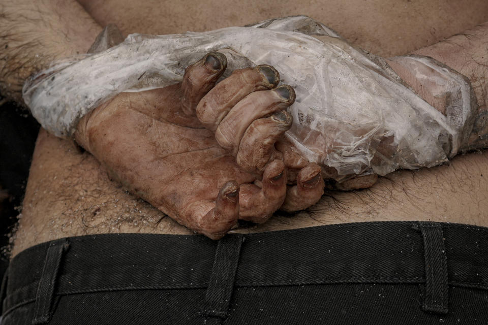 FILE - A lifeless body of a man with his hands tied behind his back lies on the ground in Bucha, Ukraine, Sunday, April 3, 2022. Russian soldiers in intercepted phone conversations called their sweeps of Bucha and other towns outside Kyiv “zachistka” – cleansing. They hunted people on lists prepared by their intelligence services and went door to door to identify and neutralize potential threats. (AP Photo/Vadim Ghirda, File)