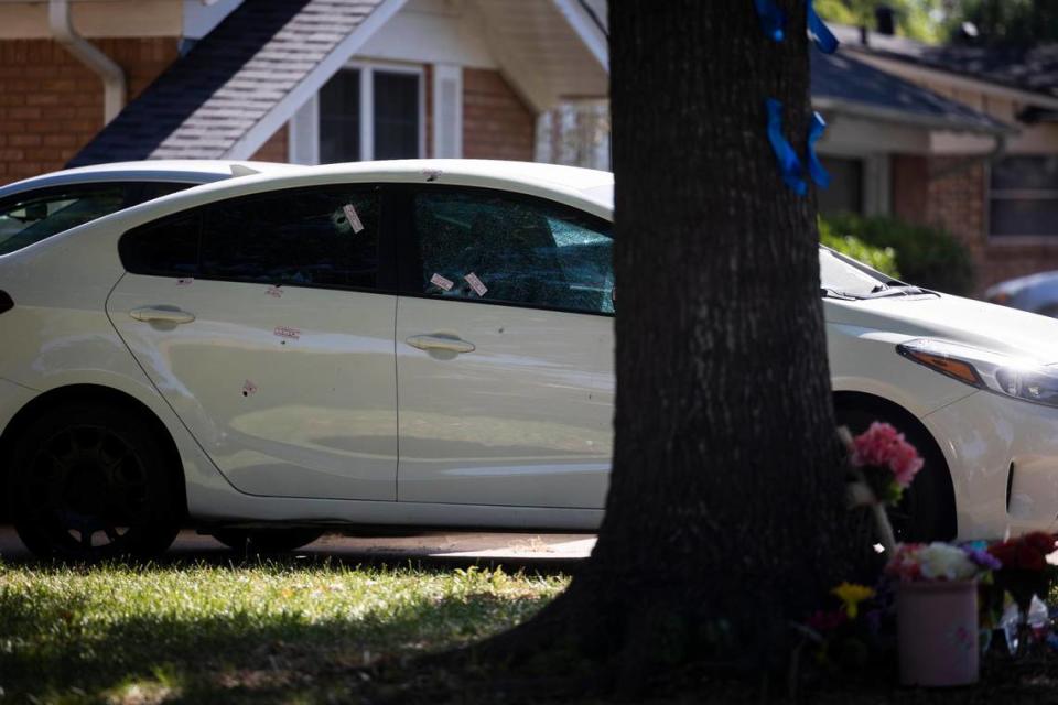 A car is riddled with bullet holes on Tuesday, July 5, 2022, in front of the residence where Saturday’s shooting killed two people in Haltom City. The gunman also shot and wounded three police officers and a woman who lives across the street before killing himself, authorities said.