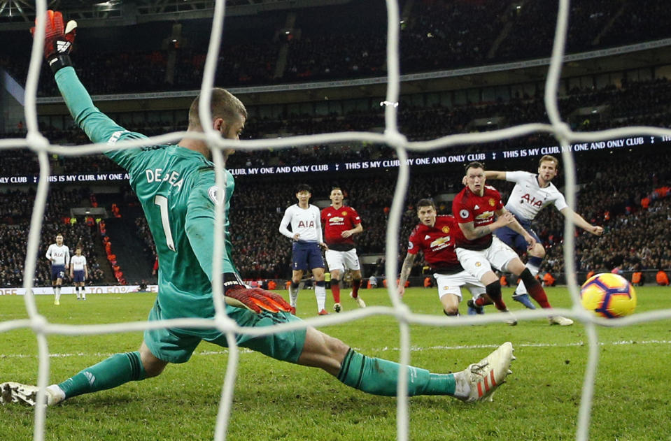 Manchester United goalkeeper David de Gea saves on a shot by Tottenham's Harry Kane, right, during the English Premier League soccer match between Tottenham Hotspur and Manchester United at Wembley stadium in London, England, Sunday, Jan. 13, 2019. (AP Photo/Matt Dunham)