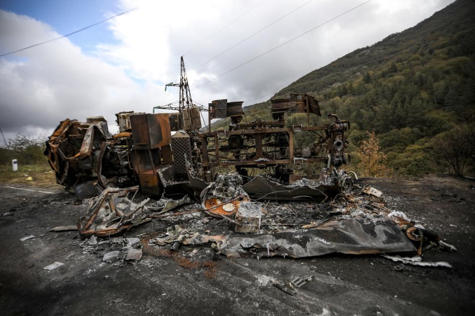 A burned Armenian truck is seen on the road on Tuesday, Oct. 3, 2023, near Khankendi, Azerbaijan, also known as Stepanakert to Armenians. (AP Photo/Aziz Karimov)