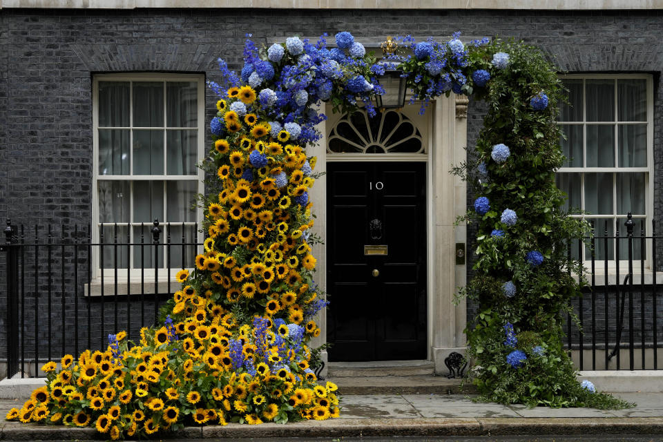 Florists have prepared the entrance to 10 Downing Street with flowers in the Ukraine national colours in London, Tuesday, Aug. 23, 2022 a day ahead of the Independence Day of Ukraine. (AP Photo/Frank Augstein)