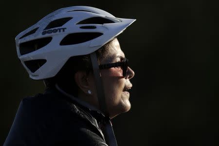 Brazil's President Dilma Rousseff rides her bicycle near the Alvorada Palace in Brasilia, July 27, 2015. REUTERS/Ueslei Marcelino