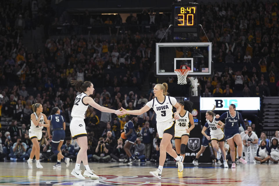 Iowa guard Sydney Affolter (3) celebrates with guard Caitlin Clark (22) after making a 3-point basket during the first half of an NCAA college basketball quarterfinal game against Penn State at the Big Ten women's tournament Friday, March 8, 2024, in Minneapolis. (AP Photo/Abbie Parr)