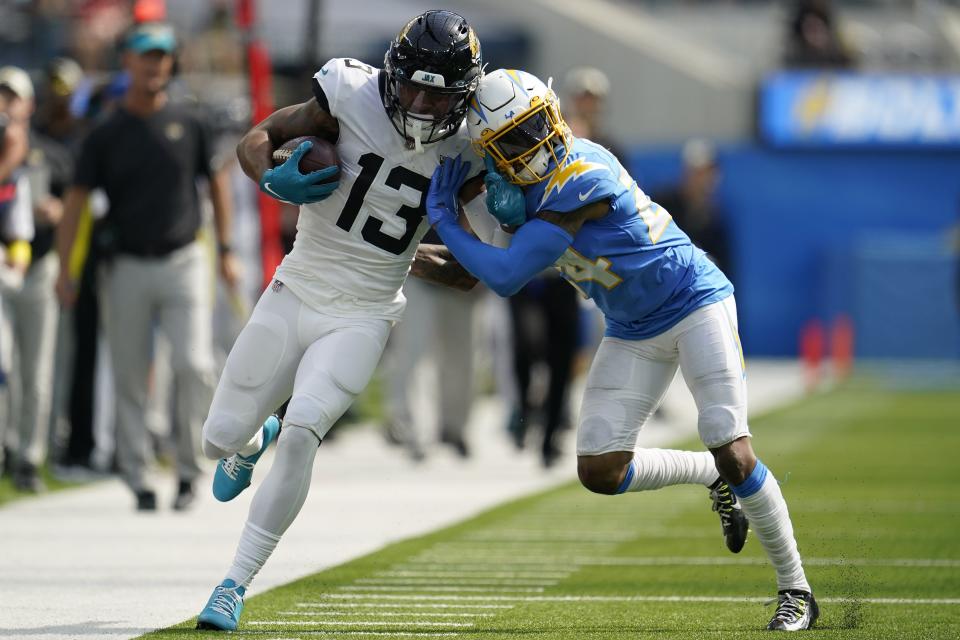 Jacksonville Jaguars wide receiver Christian Kirk (13) runs against Los Angeles Chargers safety Nasir Adderley (24) during the first half of an NFL football game in Inglewood, Calif., Sunday, Sept. 25, 2022. (AP Photo/Marcio Jose Sanchez)