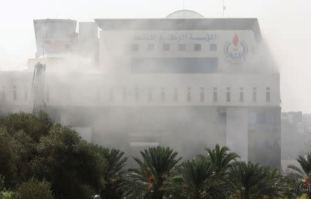 Smoke rises form the headquarters of Libyan state oil firm National Oil Corporation (NOC) after three masked persons attacked it in Tripoli, Libya September 10, 2018. REUTERS/Hani Amara