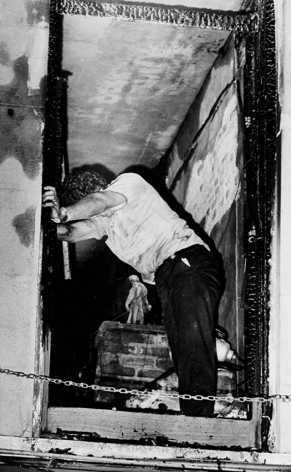 <div class="inline-image__caption"><p>A rescue worker leans against a charred window at the UpStairs Lounge. The worker was helping remove the charred bodies when he apparently couldn't face it any longer.</p></div> <div class="inline-image__credit">Pa/AP/REX/Shutterstock</div>