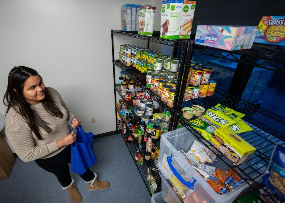 Student Pamela Delgado selects items from a food pantry at Milwaukee Area Technical College Education Center at Walker Square, 816 W. National Ave. in Milwaukee, on November 29, 2022. Food pantries are located on each MATC campus. The food is donated by Feeding America.