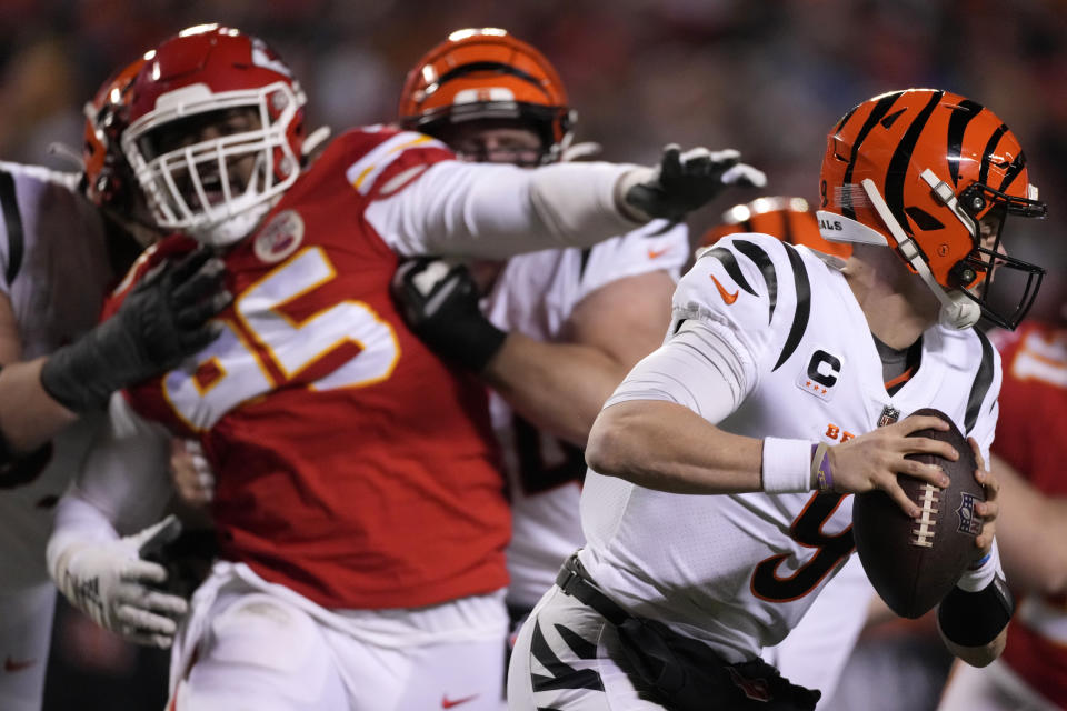 Cincinnati Bengals quarterback Joe Burrow (9) runs from Kansas City Chiefs defensive tackle Chris Jones (95) during the second half of the NFL AFC Championship playoff football game, Sunday, Jan. 29, 2023, in Kansas City, Mo. (AP Photo/Jeff Roberson)