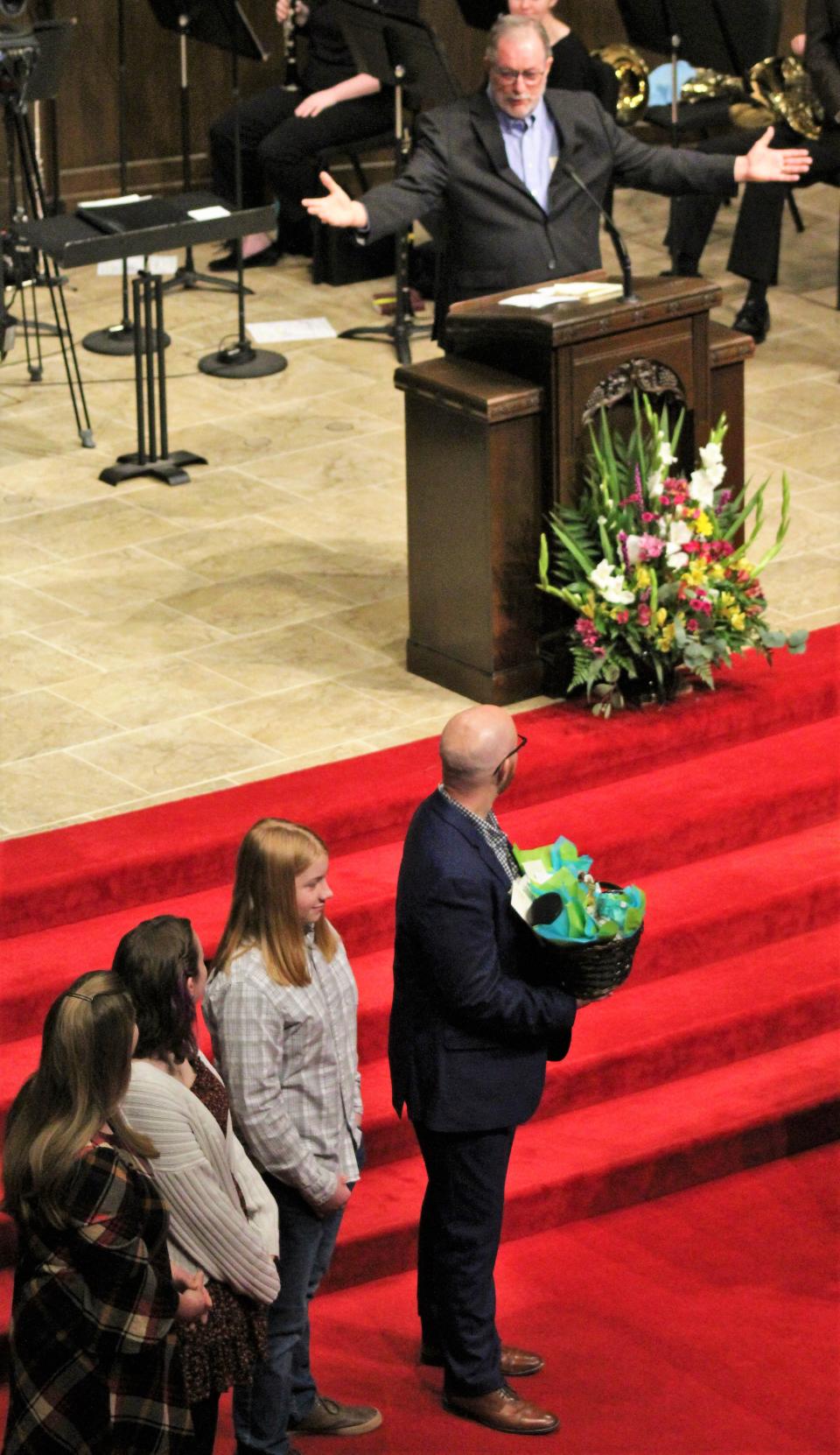 Ed Harris, arms wide, welcomes the Brandon Hudson family to First Baptist Church on Feb. 4. Hudson preached the first time, coming to Abilene from Alabama.