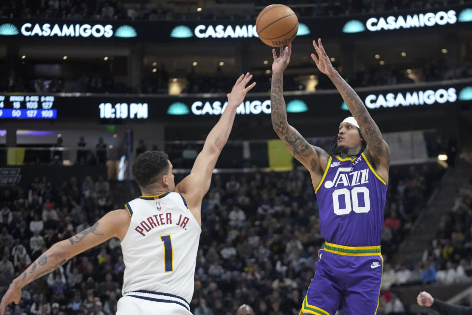 Utah Jazz guard Jordan Clarkson (00) shoots as Denver Nuggets forward Michael Porter Jr. (1) defends during the second half of an NBA basketball game Wednesday, Jan. 10, 2024, in Salt Lake City. (AP Photo/Rick Bowmer)