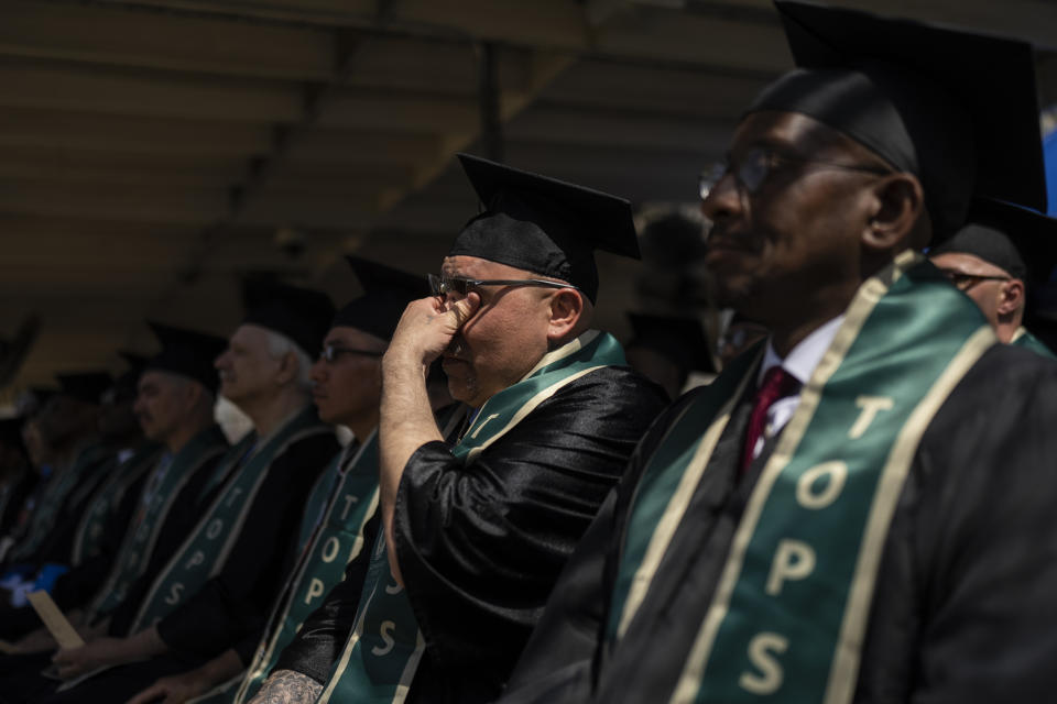 Incarcerated graduate Gabriel Bonilla, who earned a bachelor's degree in communications, wipes away tears while listening to a speech by Sacramento State President Robert Nelson during his graduation ceremony at Folsom State Prison in Folsom, Calif., Thursday, May 25, 2023. (AP Photo/Jae C. Hong)