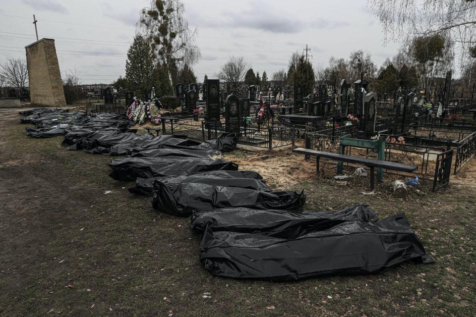 <span class="caption">Officials exhume the bodies of civilians killed in a Russian attack.</span> <span class="attribution"><a class="link " href="https://www.gettyimages.com/detail/news-photo/officials-exhume-the-bodies-of-civilians-who-died-during-news-photo/1239895652?adppopup=true" rel="nofollow noopener" target="_blank" data-ylk="slk:Metin Aktas/Anadolu Agency via Getty Images;elm:context_link;itc:0;sec:content-canvas">Metin Aktas/Anadolu Agency via Getty Images</a></span>