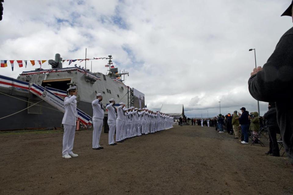 Crew of the USS Minneapolis-Saint Paul salute during Saturday's commissioning in Duluth, Minn. of the new littoral combat ship, which will be based at Naval Station Mayport.