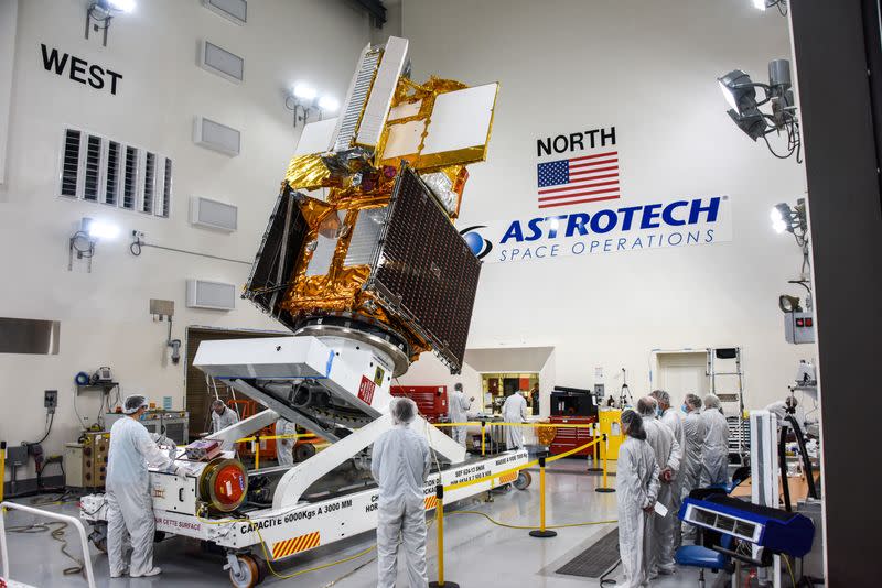 The Surface Water and Ocean Topography (SWOT) radar satellite spacecraft is moved into a transport container inside the Astrotech facility at Vandenberg Space Force Base