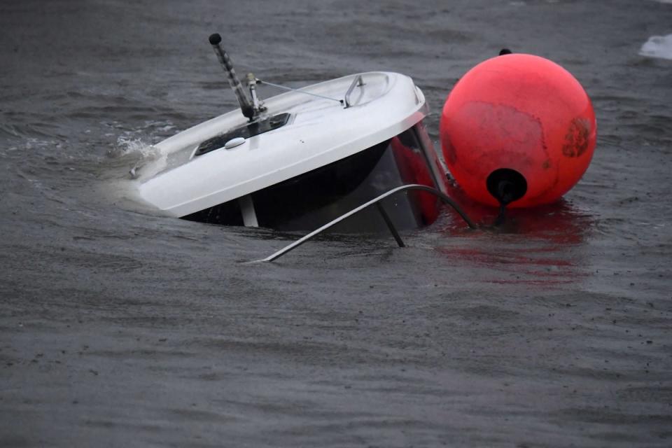 A boat sinks inside the harbour in Stonehaven on the east coast of Scotland (AFP via Getty Images)
