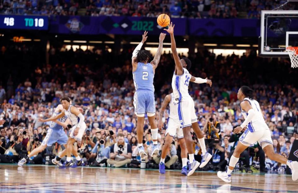 North Carolina’s Caleb Love (2) hits a three-pointer with 25 seconds left in the game to give the Tar Heels a 78-74 lead during the second half of UNCs 81-77 victory over Duke in the Final Four at Caesars Superdome in New Orleans, La., Saturday, April 2, 2022. Dukes Mark Williams (15) defends.