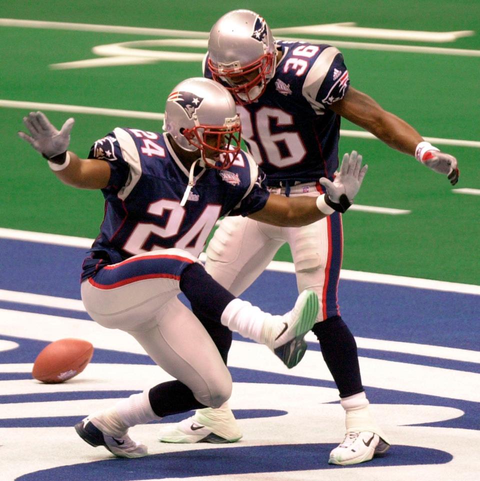 New England Patriots cornerback Ty Law (24) celebrates his interception for a touchdown against St. Louis in the second quarter of Super Bowl XXXVI, with teammate Lawyer Milloy at the Louisiana Superdome in New Orleans on Feb. 3, 2002.