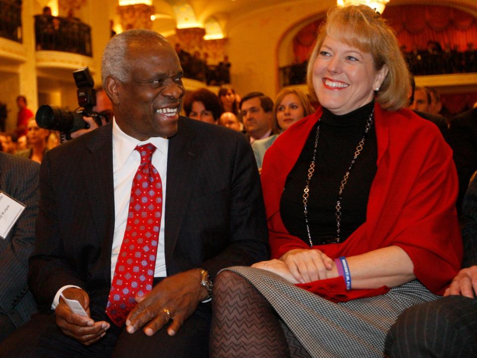Supreme Court Justice Clarence Thomas sits with his wife Virginia Thomas in Washington.