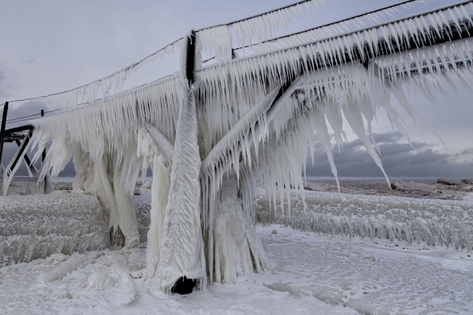 SOUTH HAVEN, MI - JANUARY 8: Ice hangs from the railings at St Joseph Lighthouse, on January 8, 2015, in South Haven, Michigan.ICE engulfs a red lighthouse as a fierce winter storm grips South Haven, Michigan. Sharp icicles and surreal formations can be seen hanging from the railings after strong waves crashed onto the piers. After each coating the water quickly freezes to ice and the pier is transformed into a slippery, white wonderland. Weather in the area dipped into the minus figures and froze over Lake Michigan in the beginning of January.PHOTOGRAPH BY Mike Kline / Barcroft MediaUK Office, London.T +44 845 370 2233W www.barcroftmedia.comUSA Office, New York City.T +1 212 796 2458W www.barcroftusa.comIndian Office, Delhi.T +91 11 4053 2429W www.barcroftindia.com