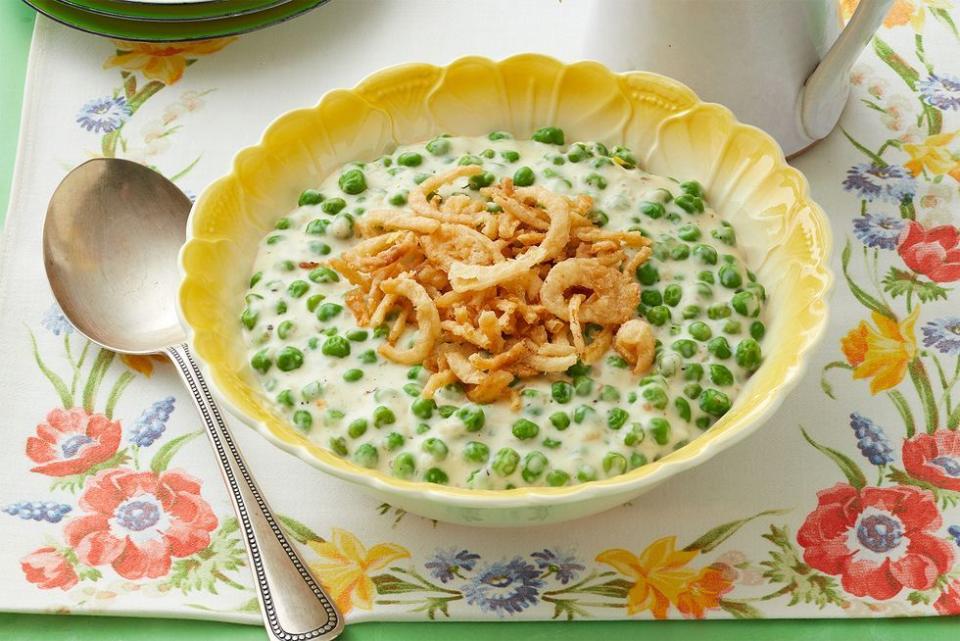 cream peas in bowl with crispy onions